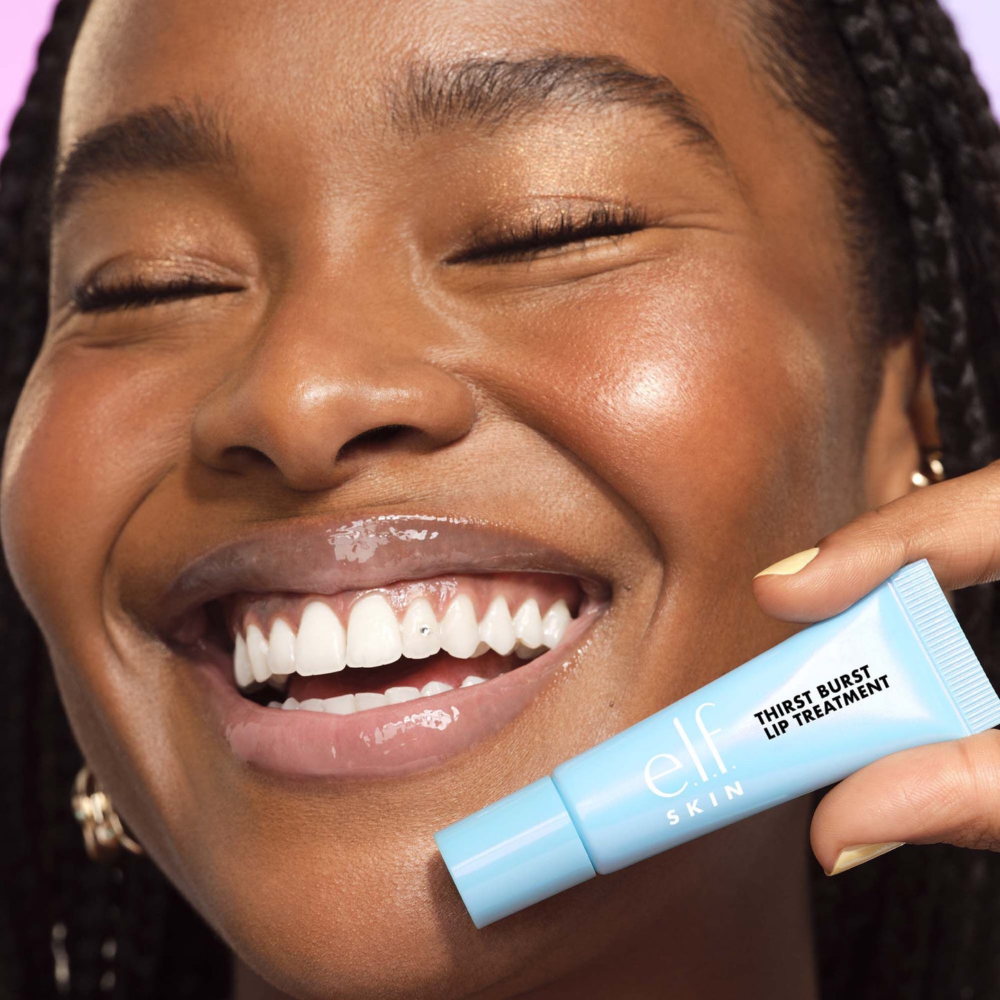 Woman Wearing and Holding Thirst Burst Blue Hibiscus Lip Treatment