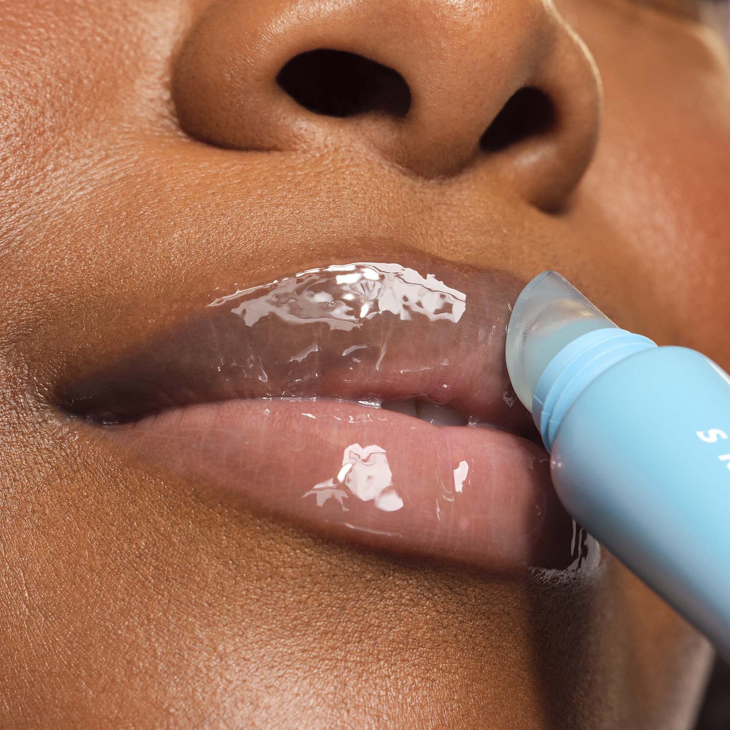 Woman Applying Thirst Burst Blue Hibiscus Lip Treatment